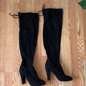 Thigh high, tie back heeled boots.